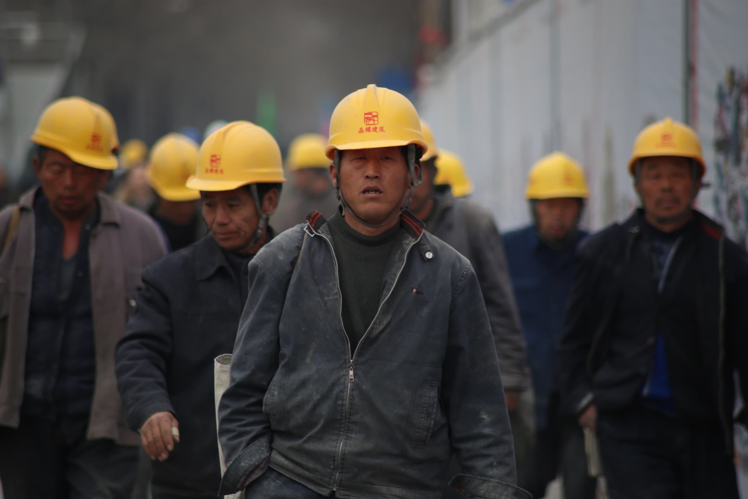group of worker wearing yellow safety helmet
